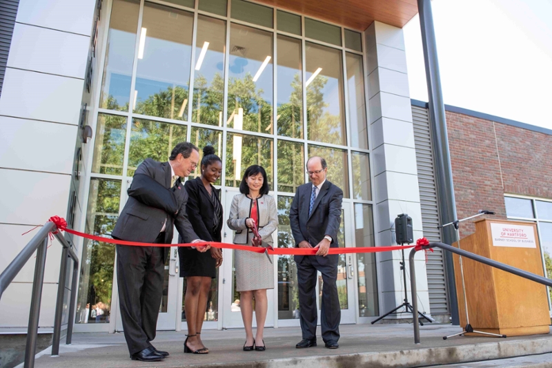 pres woodward, student ninamarie ayala, dean zeng, donald allan cut ribbon